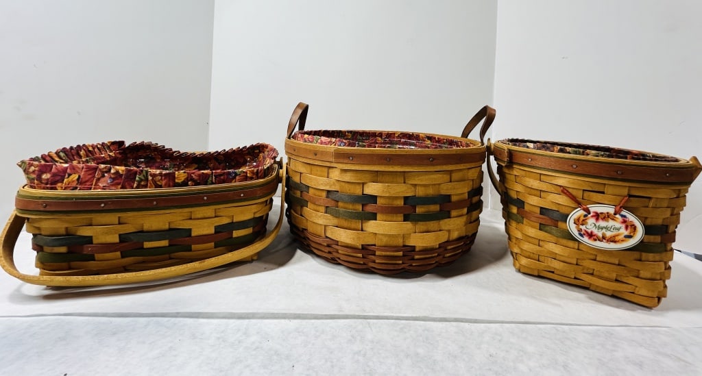 A Trio of Longaberger Handwoven Wooden Baskets in the Shades of Autumn Pattern: This lot consists of three handwoven wooden splint baskets produced by Longaberger Baskets of Dresden, Ohio, USA. The pieces belong to the Shades of Autumn series, featuring natural wood construction 