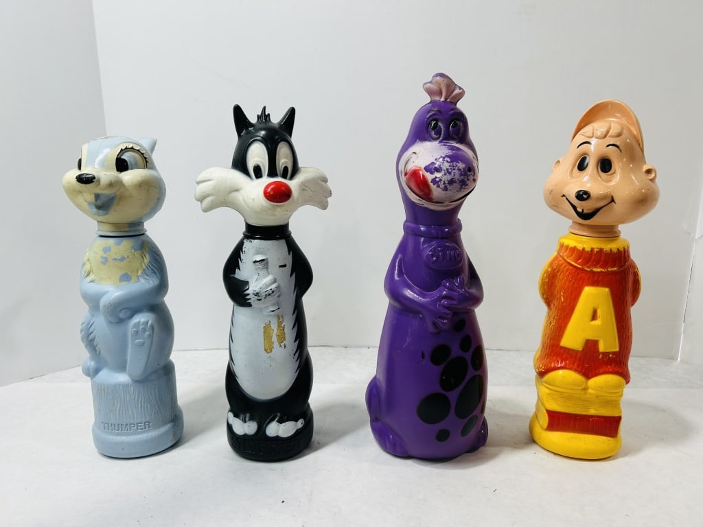 Four Vintage Soaky Character Bubble Bath Bottles: A set of four vintage molded plastic character bubble bath bottles, commonly referred to as Soaky bottles, attributed to Colgate-Palmolive. The collection includes characters from various animation fr