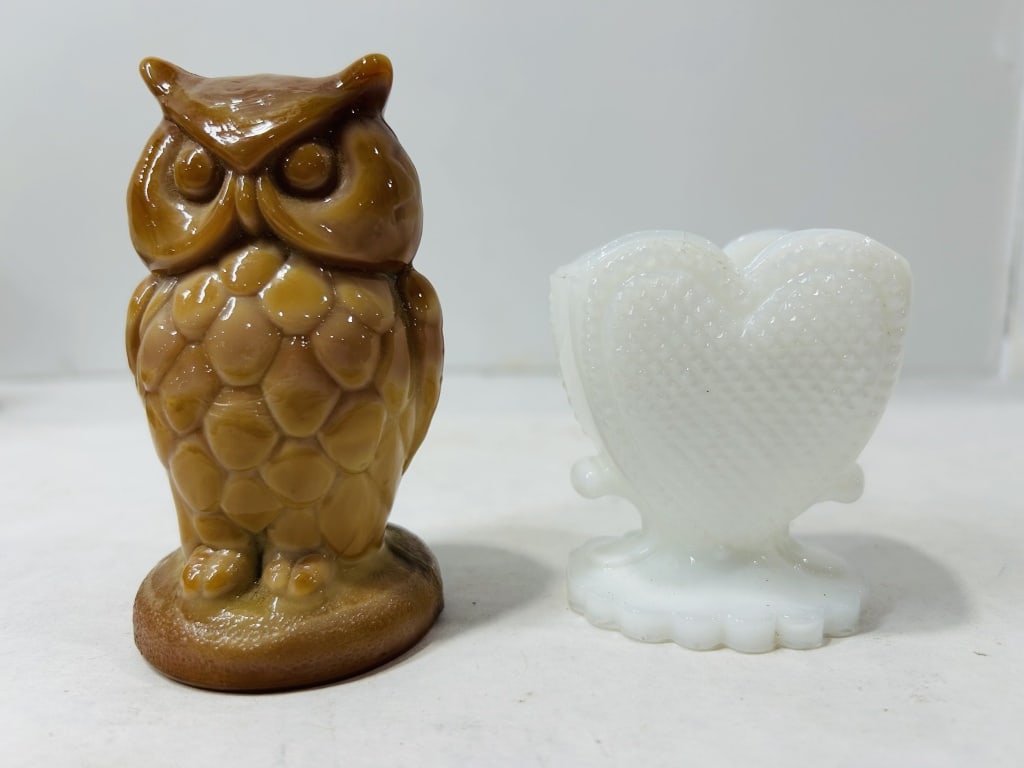 Glass Items Including a Mosser Slag Glass Owl Figurine: This lot features two decorative glass pieces, comprising a caramel slag glass owl figurine and a white milk glass heart-shaped pedestal vessel. The owl figurine is crafted from marbled brown and tan 
