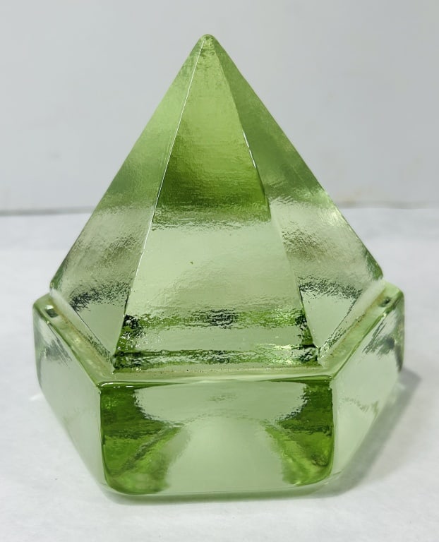 Green Glass Hexagonal Deck Prism: A decorative object in the form of a hexagonal nautical deck prism, crafted from translucent light green glass. The piece is composed of a hexagonal base surmounted by a matching hexagonal pyramid tap