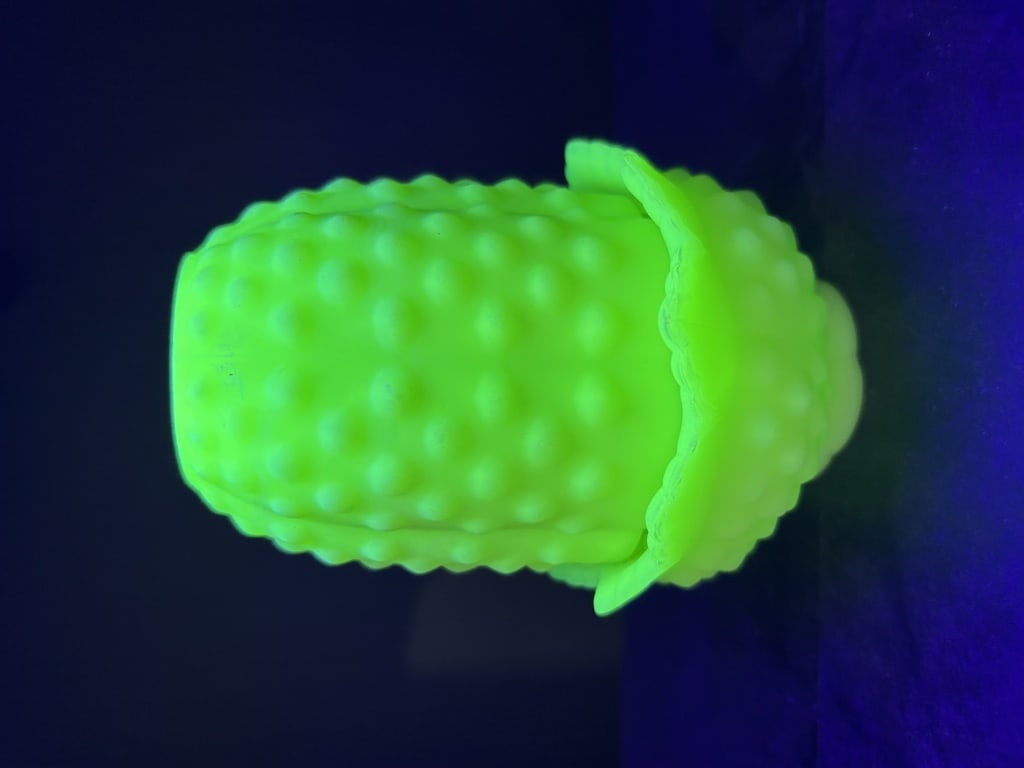 Vintage Uranium Custard Glass Maize Pattern Two-Piece Fairy Lamp: This two-piece decorative item, commonly known as a fairy lamp or candle lamp, is crafted from opaque lime green custard glass. The design features a Maize or Corn pattern, consisting of a cylindrical