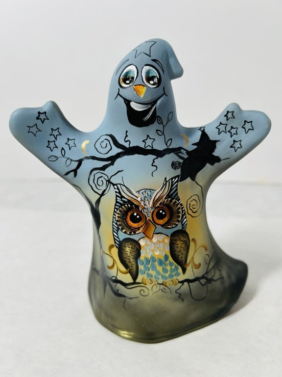 Fenton Limited Edition Hand-Painted Art Glass Halloween Ghost Figurine by Kim Barley: A hand-painted Fenton Art Glass ghost figurine featuring a satin-finish gradient transitioning from blue at the top to a smoky olive green translucent base. The front of the piece displays a central o