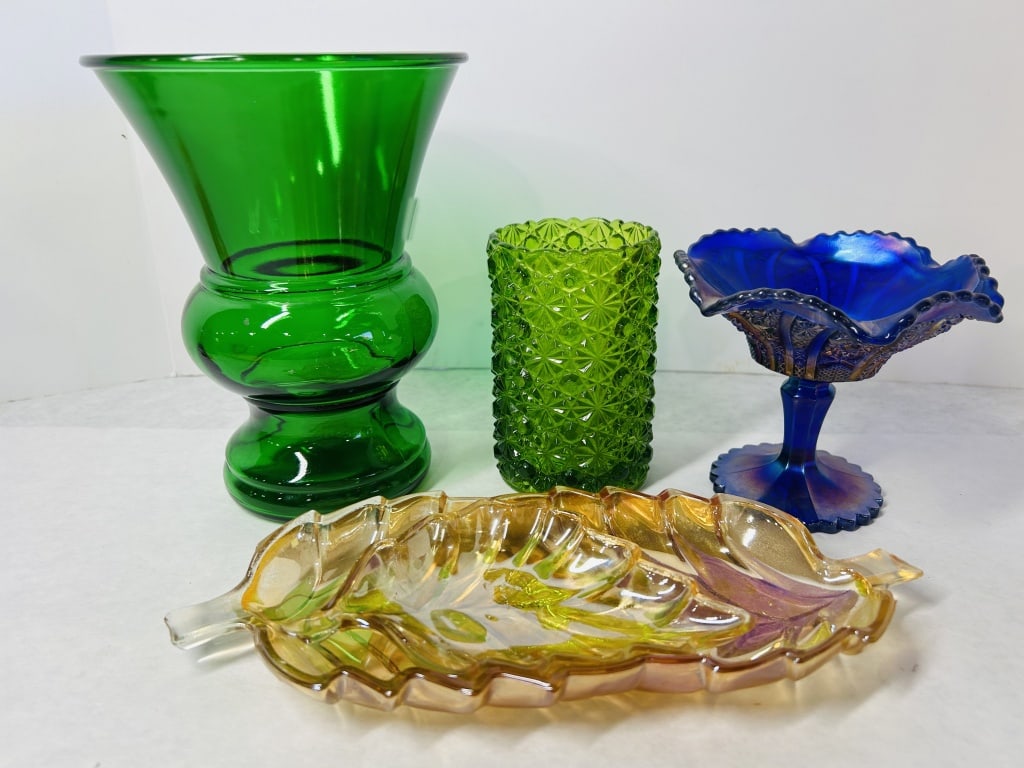 An Assortment of Vintage Carnival and Pressed Glass Decorative Items: This lot features a collection of vintage decorative glass pieces from the mid-20th century, including examples of carnival and pressed glass. Included is a large emerald green glass pedestal vase wit