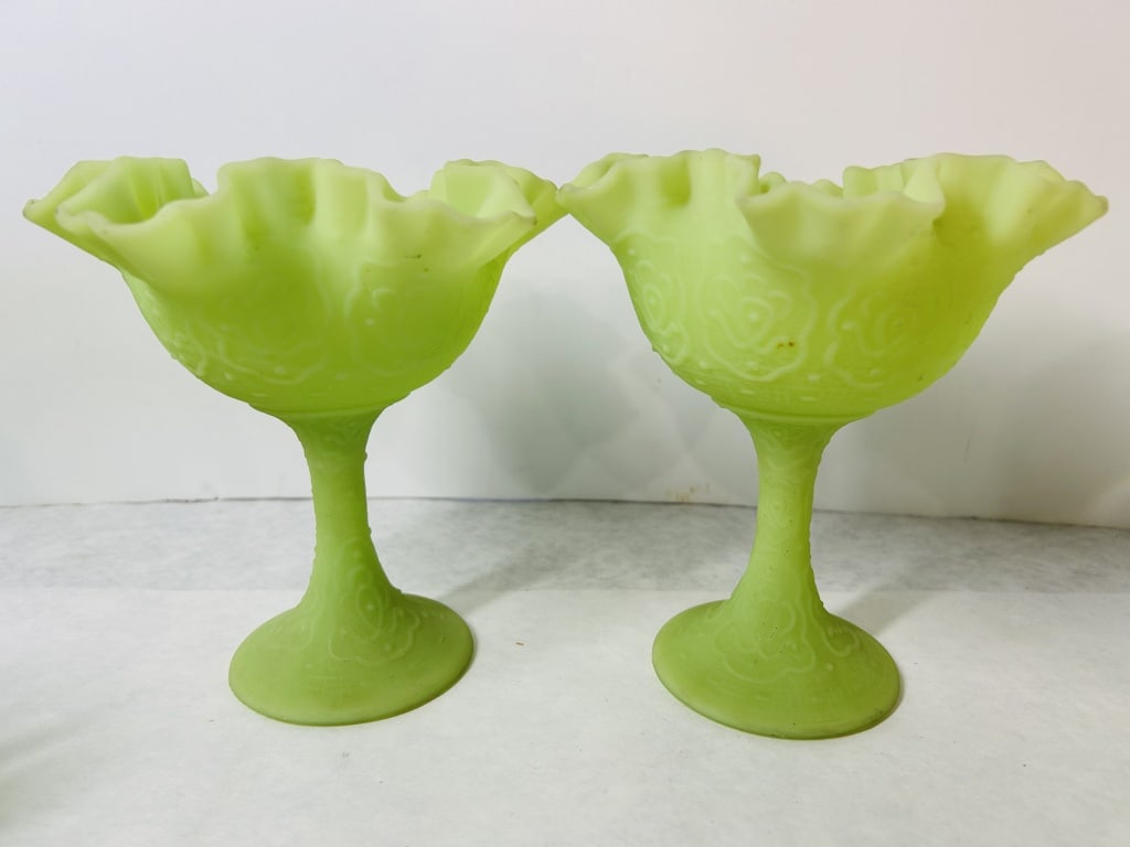 A Pair of Fenton Persian Medallion Pattern Satin Custard Uranium Glass Compotes: This pair of compotes was produced by the Fenton Art Glass Company in the Persian Medallion pattern. Each piece is crafted from uranium glass with a matte finish, known as satin custard glass. The ite
