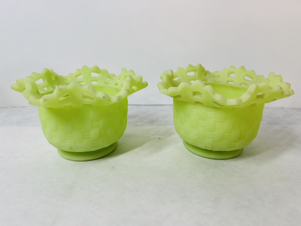 A Pair of Fenton Custard Uranium Glass Basketweave with Lattice Rim Bowls: This is a pair of pressed custard glass bowls manufactured by the Fenton Art Glass Company. The items feature a satin finish and are crafted from uranium glass, which produces a distinctive bright gre