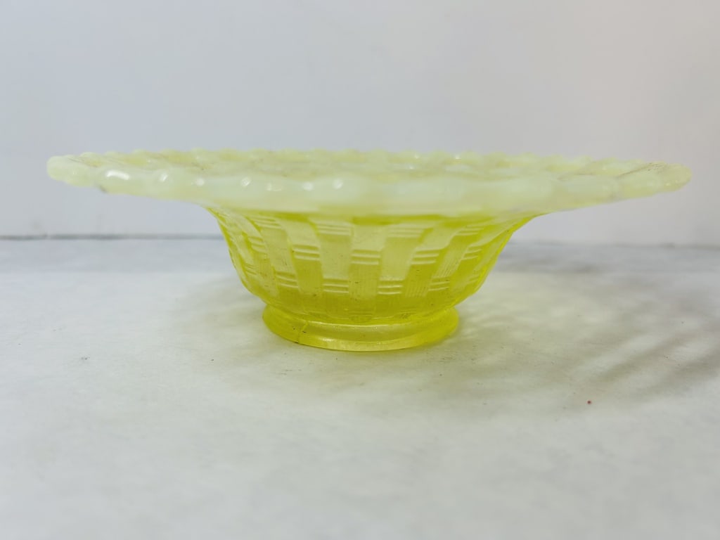 Attributed to Fenton Art Glass Canary Yellow Uranium Glass Basketweave Bowl with Open Edge Rim: This bowl is attributed to Fenton Art Glass and is crafted in the Basketweave with Open Edge pattern. It is made from canary yellow uranium glass, often referred to as Vaseline glass due to its yellow