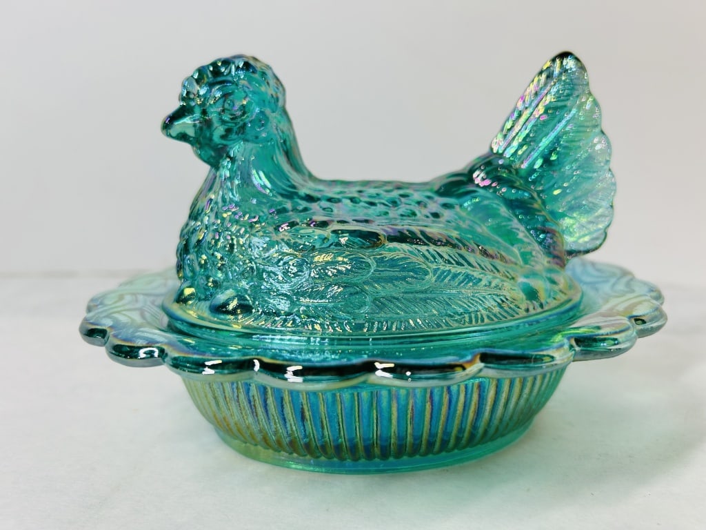 Mosser Glass Teal Carnival Glass Hen on Nest Covered Dish: This vintage two-piece covered dish, known as a Hen on Nest, is crafted from teal aqua glass with a lustrous carnival glass iridescent finish. The finish displays a vibrant spectrum of metallic colors
