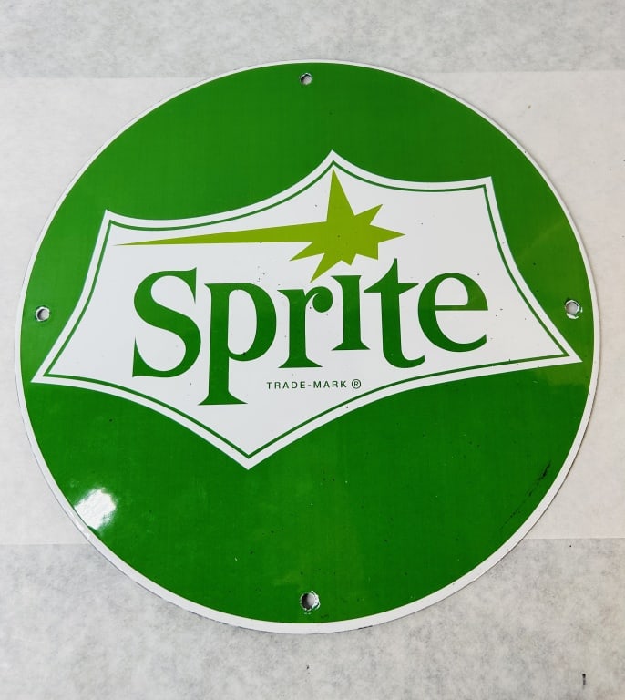 Sprite Officially Licensed Circular Porcelain Enamel Advertising Sign: Circular porcelain enamel advertising sign for Sprite, a brand of The Coca-Cola Company. The sign features the starburst logo design with the brand name in a green serif typeface and a green starburst
