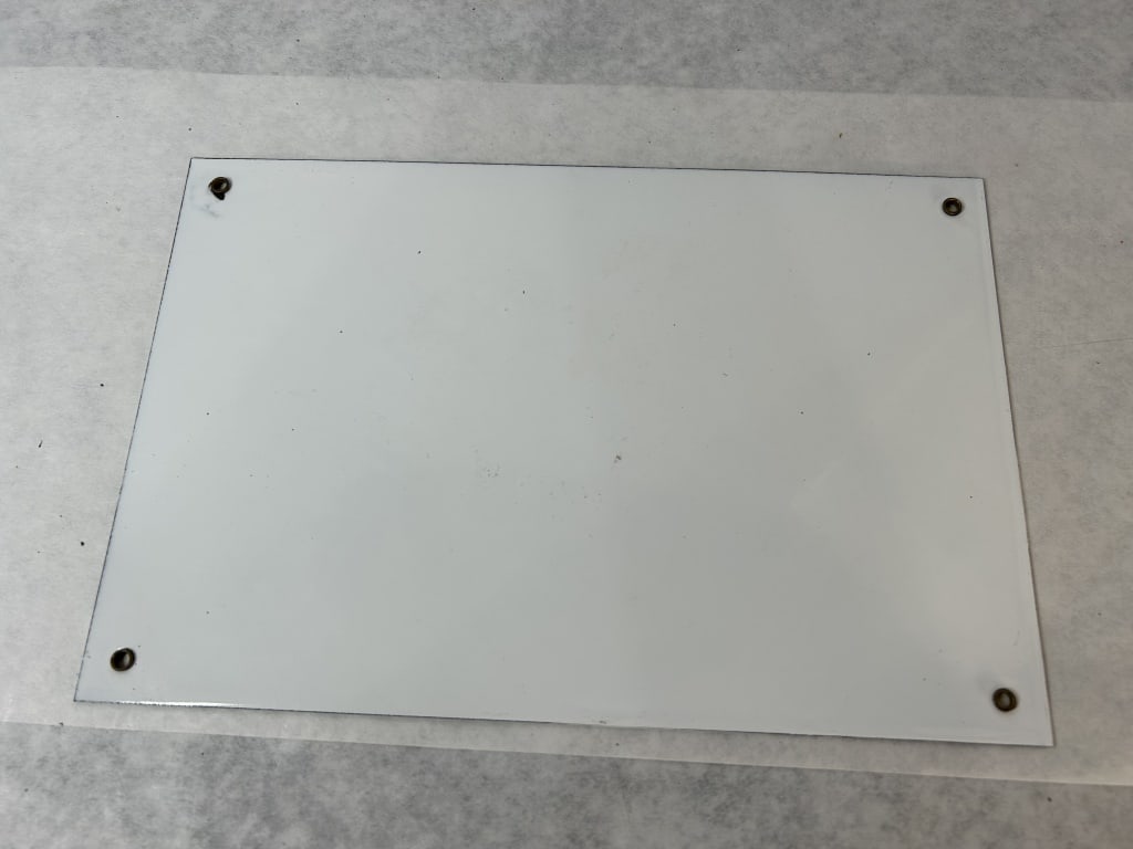 1999 Coca-Cola Porcelain Enamel Advertising Sign: This is an authorized reproduction Coca-Cola advertising sign produced in 1999. The rectangular sign is made of porcelain enamel on metal. The design features a green sunburst background with a centra