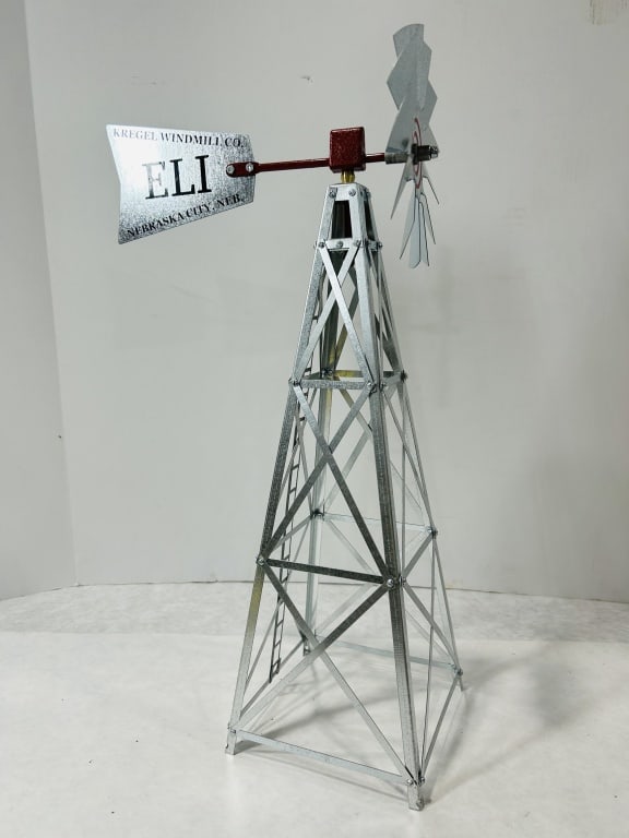 Kregel Windmill Co. Eli Scale Model Windmill: This scale model represents the Eli windmill, a historical design by the Kregel Windmill Co. of Nebraska City, Nebraska. The structure is built from galvanized metal, featuring a tapered four-post lat