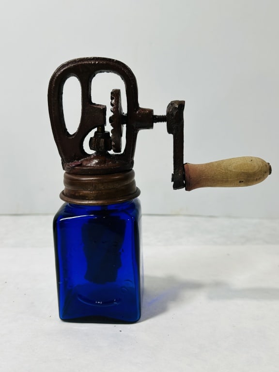 Vintage S. J. and Co. Philadelphia Cobalt Blue Glass Hand-Crank Butter Churn: This manual hand-crank butter churn is composed of a square-bodied cobalt blue glass jar and a cast iron mechanical top assembly. The glass jar features embossed identification on one face, with S. J.