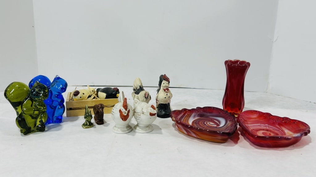 An Assortment of Vintage Glass and Ceramic Decorative Figurines, Dishes, and Shakers: This collection consists of various mid-century decorative glass and ceramic objects. The glassware includes two molded glass squirrel figurines, one in transparent emerald green and one in cobalt blu