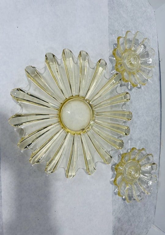 A Three-Piece Yellow Depression Glass Console Set in the Style of Federal Glass: This three-piece console set is composed of transparent yellow pressed glass, characteristic of American tableware produced during the Depression era circa the 1930s. The set includes one large circul