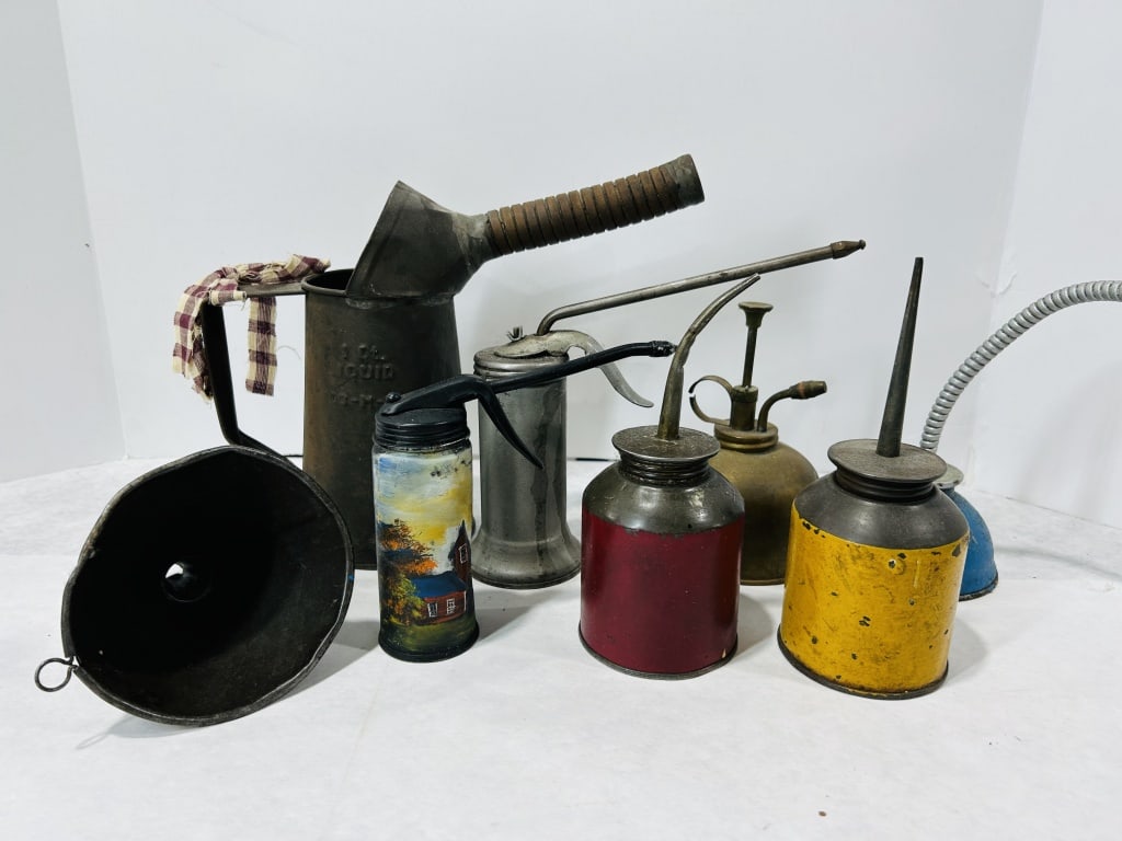 A Collection of Vintage Automotive and Industrial Oiling Tools including Eagle and Hand-Painted: This assortment features a variety of vintage maintenance tools typically found in mid-20th-century service stations and industrial shops. The collection is comprised of several pump oilers, a liquid 