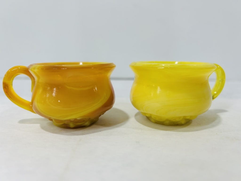 A Pair of Boyd Art Glass Miniature Slag Glass Cauldrons: A pair of miniature slag glass cauldrons produced by Boyd Art Glass of Cambridge, Ohio. Each vessel is crafted from opaque swirled glass, also referred to as marble glass, in two distinct colorways: o
