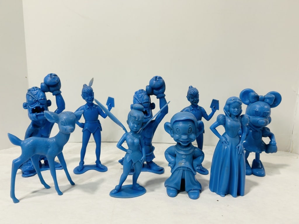 Nine Vintage Monochrome Blue Plastic Figures Attributed to Louis Marx and Company: This lot consists of nine vintage monochrome figurines molded from blue plastic. The collection features several characters from Walt Disney productions alongside two stylized novelty caricature figur