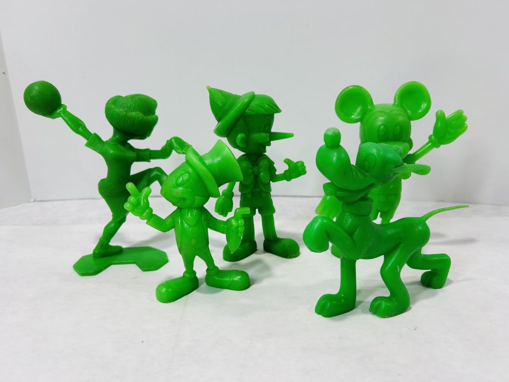 Five Vintage Disney Character Figurines Attributed to Louis Marx and Co: This collection consists of five vintage Disney character figurines. Each piece is crafted from solid green molded plastic in a monochromatic finish. The set includes representations of Mickey Mouse, 