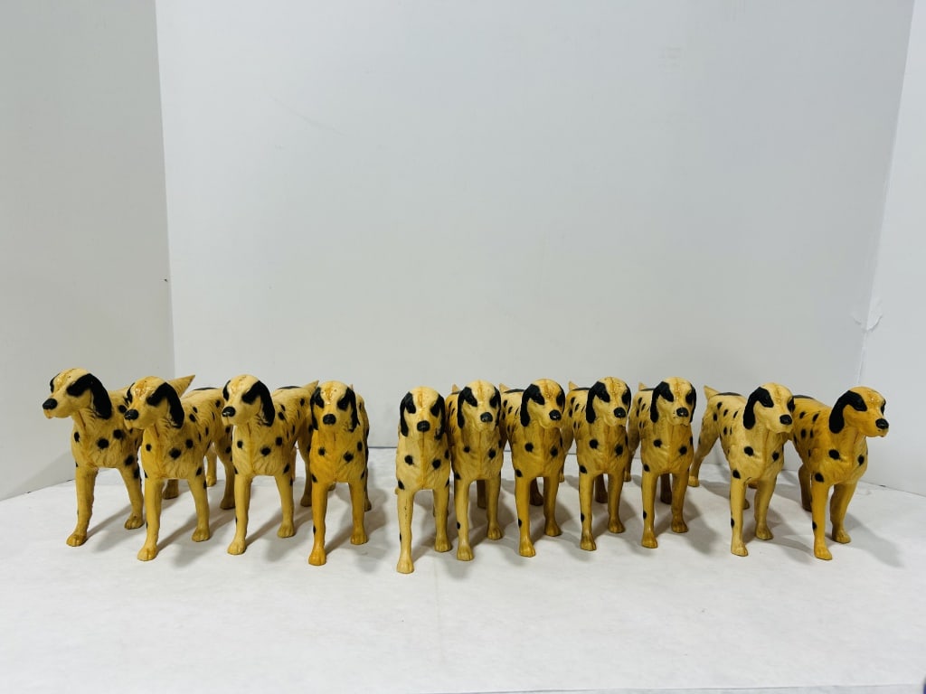 A Collection of Vintage Yellow and Black Spotted Toy Dog Figurines: A collection of matching vintage toy dog figurines attributed to Mortens Studio. The figures depict Dalmatian or pointer-style dogs in a standing pose. Each item is manufactured from molded hard plast