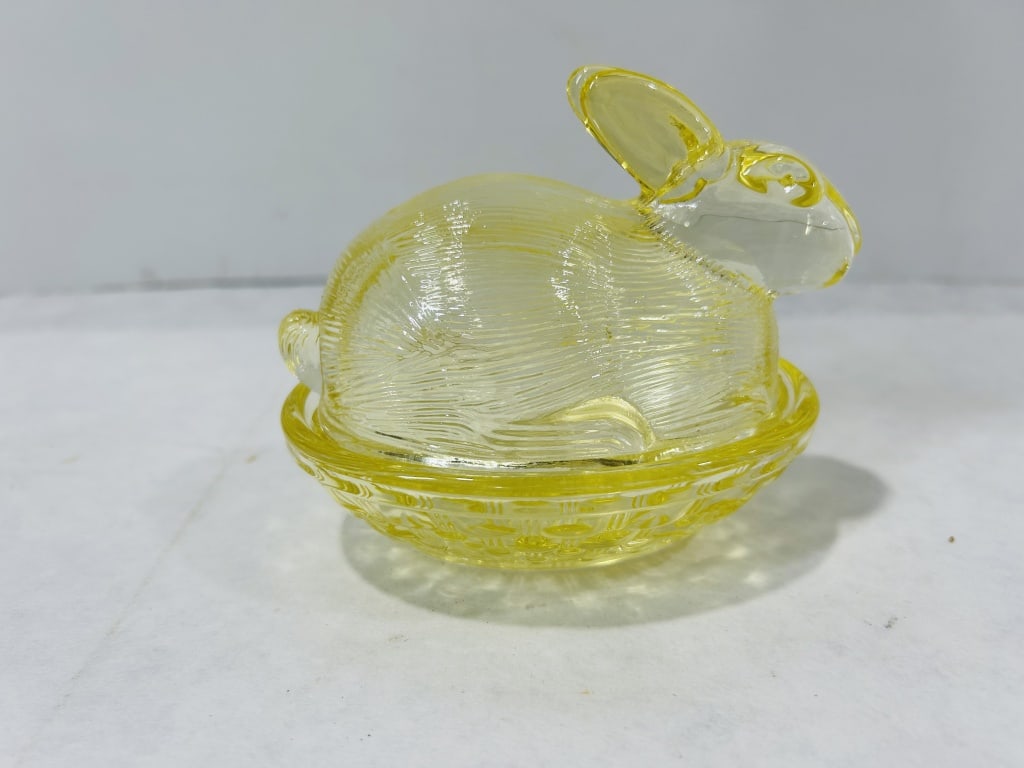 Yellow Pressed Glass Rabbit on Basket Lidded Dish: A two-piece decorative lidded dish crafted from translucent canary yellow pressed glass. The lid is molded into the form of a crouching rabbit with parallel textured lines across the body to represent