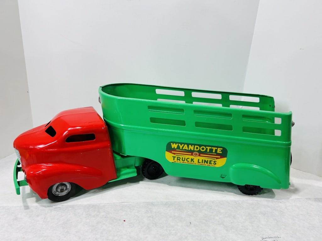Wyandotte Toys Truck Lines Pressed Steel Semi Truck and Trailer: This articulated semi-truck and trailer toy was manufactured by the All Metal Products Co. under the Wyandotte Toys brand. The toy is constructed from pressed steel and features a tractor with a red f