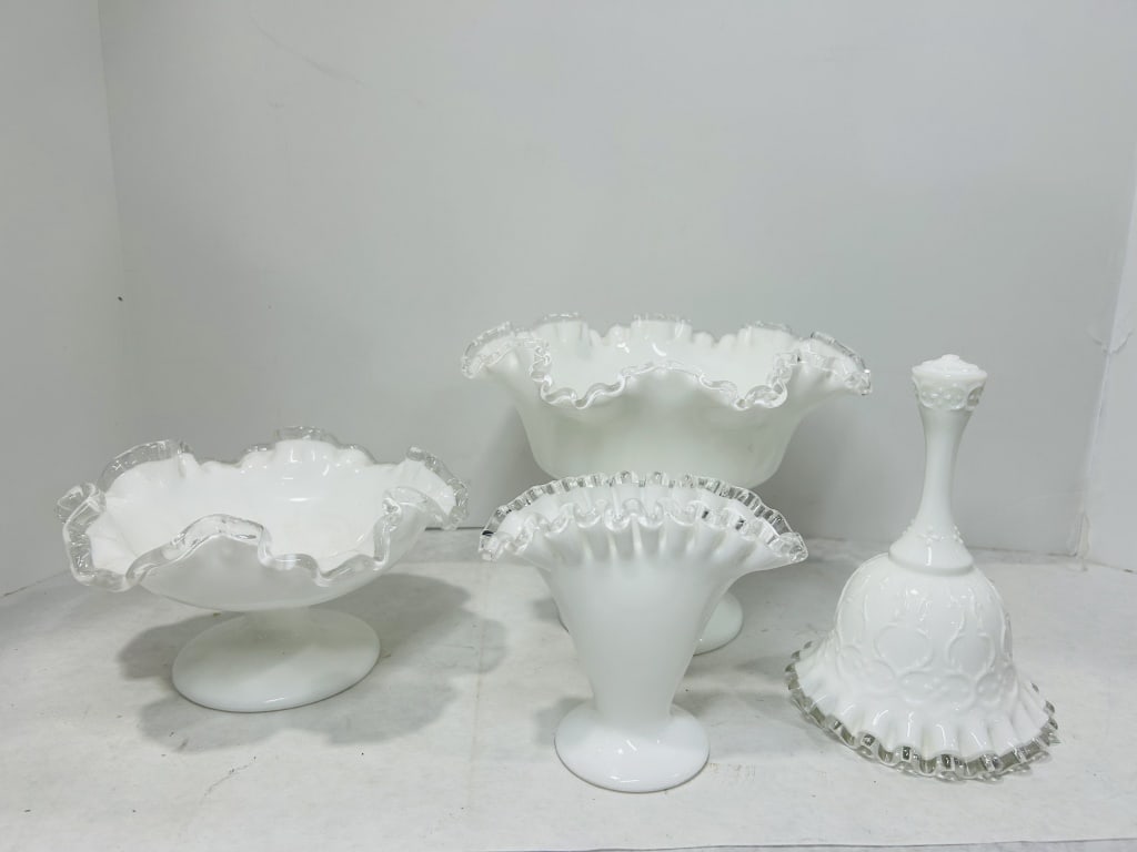 A Four-Piece Collection of White Milk Glass with Clear Ruffled Edges in the Silver Crest Style: This four-piece collection of vintage white milk glass is produced in the Silver Crest pattern, attributed to the Fenton Art Glass Company of the United States. Each piece is characterized by an opaqu