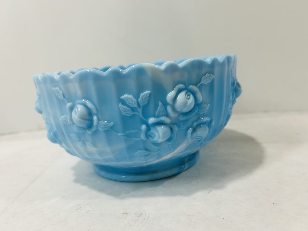 Vintage Blue Slag Glass Rose Pattern Footed Bowl: A vintage footed bowl made of blue slag glass, featuring an opaque swirled or marbled appearance with white. The exterior displays a raised relief pattern of roses and leaves against a vertically ribb