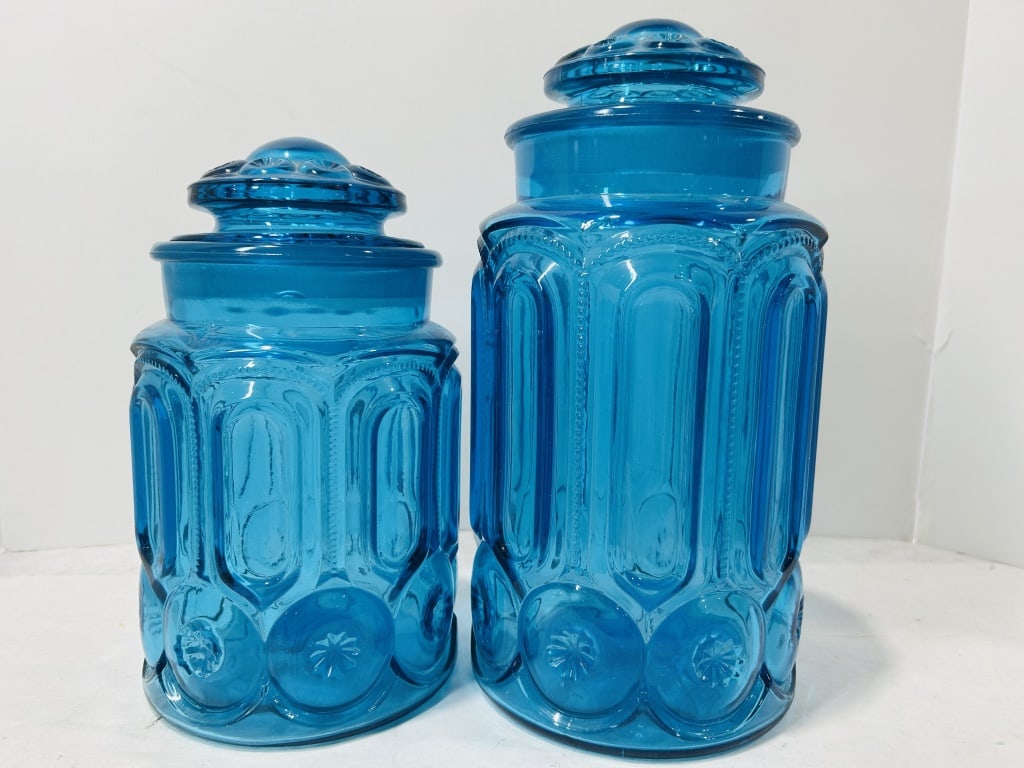 L.E. Smith Attributed Moon and Star Pattern Blue Glass Canisters: A graduated pair of pressed glass canisters in the Moon and Star pattern, attributed to the L.E. Smith Glass Company. The set consists of two canisters of different heights, both produced in a vibrant