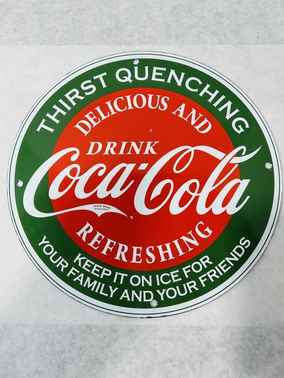 Coca-Cola Circular Metal Advertising Sign: This circular advertising sign is a licensed reproduction of a vintage Coca-Cola design, attributed to Desperate Enterprises. The sign is constructed of metal with a painted or enameled finish, featur