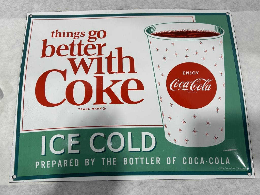 Coca-Cola Porcelain Enamel Advertising Sign Things Go Better With Coke: A rectangular porcelain enamel advertising sign for Coca-Cola featuring a white upper field and a green horizontal band across the bottom. The main body of the sign displays the slogan things go bette