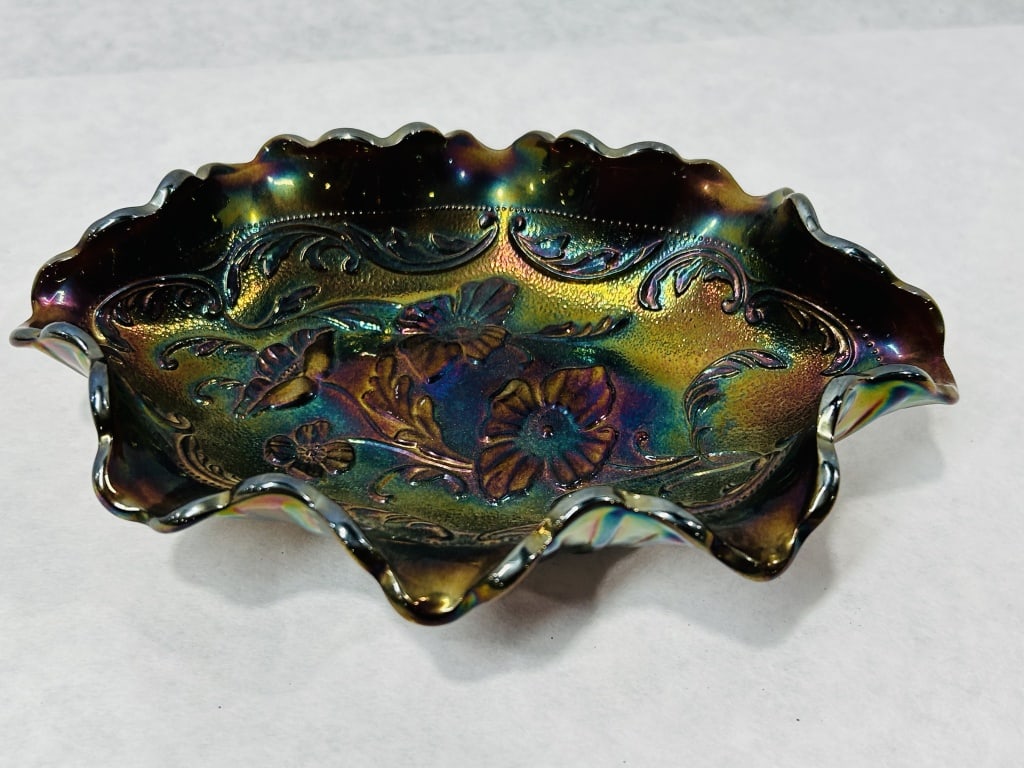 Fenton Amethyst Carnival Glass Three Poppies Ruffled Oval Bowl: This is a piece of pressed carnival glass produced by the Fenton Art Glass Company. The bowl is made from dark amethyst glass with a multi-color iridescent finish that displays metallic highlights of 