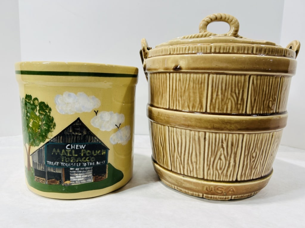 Two Pieces of American Ceramic Stoneware Including an Attributed McCoy Old Oaken Bucket Cookie Jar: This lot contains two American ceramic storage jars. The first is a cylindrical crock featuring a cream-colored glaze and dark green banding at the rim and base. The exterior is decorated with a hand-