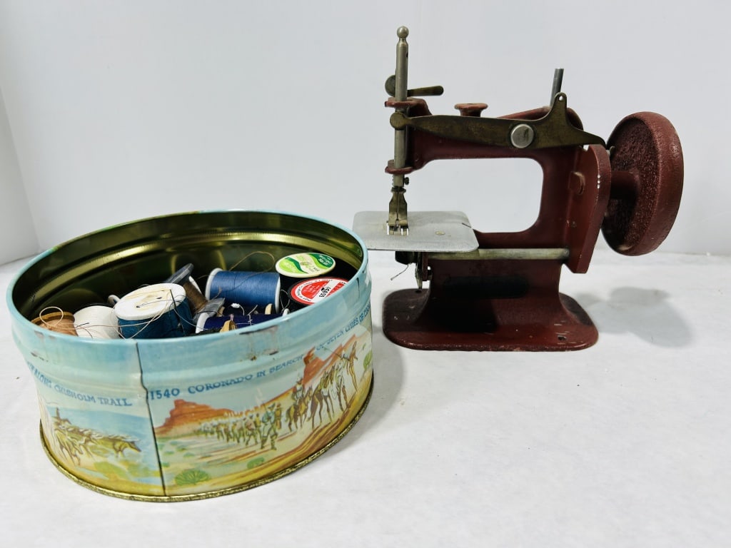 A Vintage Hand-Crank Toy Sewing Machine and Lithographed Tin with Sewing Supplies (1 of 4)