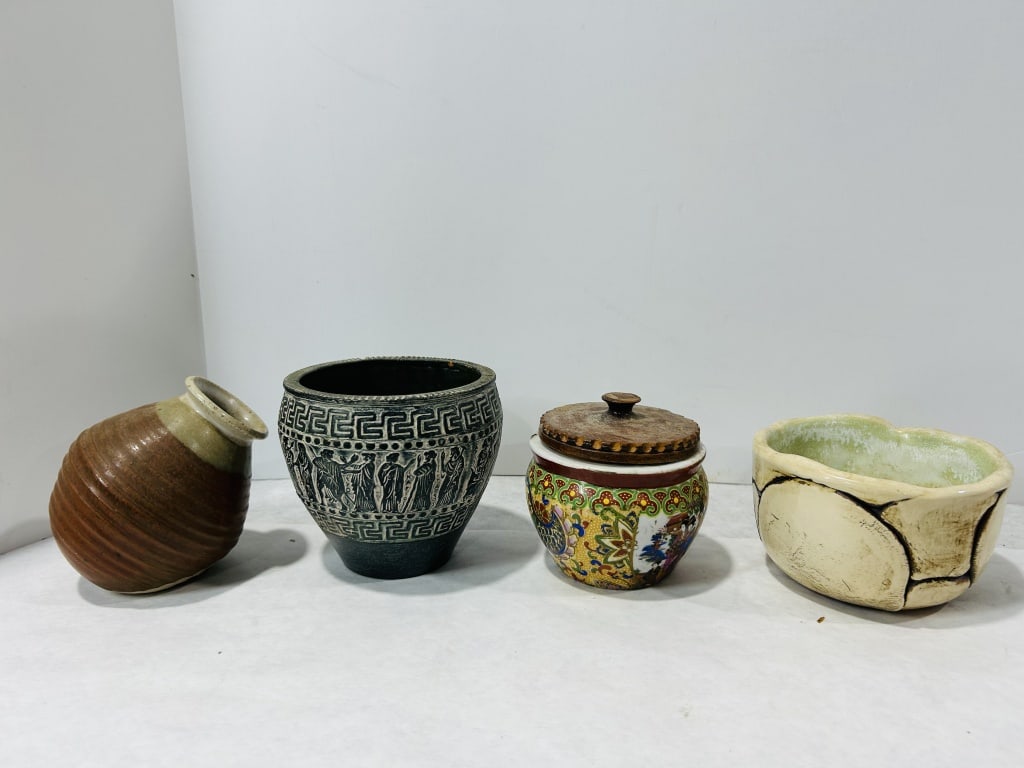 An Assortment of Studio and Decorative Ceramic Vessels: An assortment of decorative ceramic vessels featuring varied production techniques and historical styles. The collection includes a stoneware vase with horizontal ridged bands and a two-tone glaze, ma