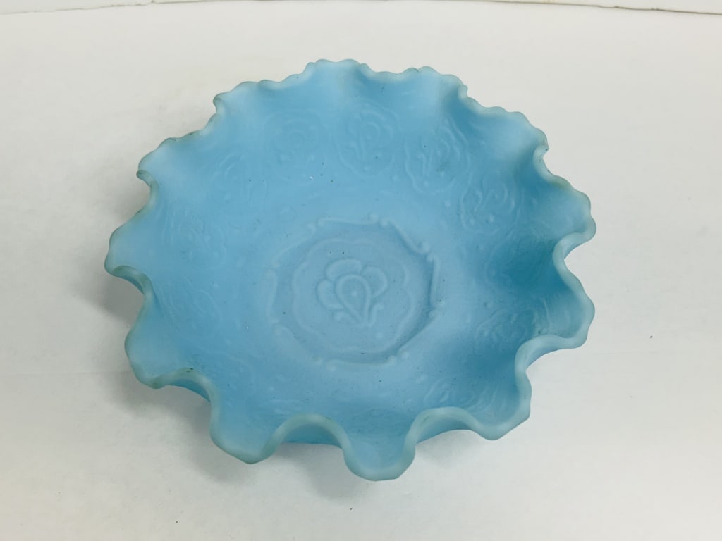 FENTON BLUE SATIN GLASS BOWL: Blue satin glass ruffled bowl produced by the Fenton Art Glass Company in the Persian Medallion pattern. A raised oval mark with Fenton in script is present on the underside of the footed base.