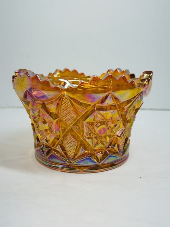 MOSSER MARIGOLD CARNIVAL GLASS FINGER BOWL: This pressed glass finger bowl by Mosser Glass features a marigold iridescent finish and a geometric star and diamond pattern with a serrated rim. A gold foil label is affixed to the interior base ide