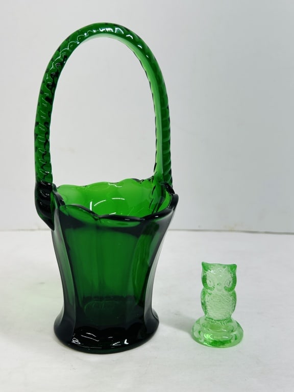 BOYD AND INDIANA GREEN GLASS, 1980S: Two pieces of decorative glass comprising a marked Boyd's Crystal Art Glass uranium owl figurine and an emerald green basket attributed to Indiana Glass. The owl bears a molded diamond B mark on the r