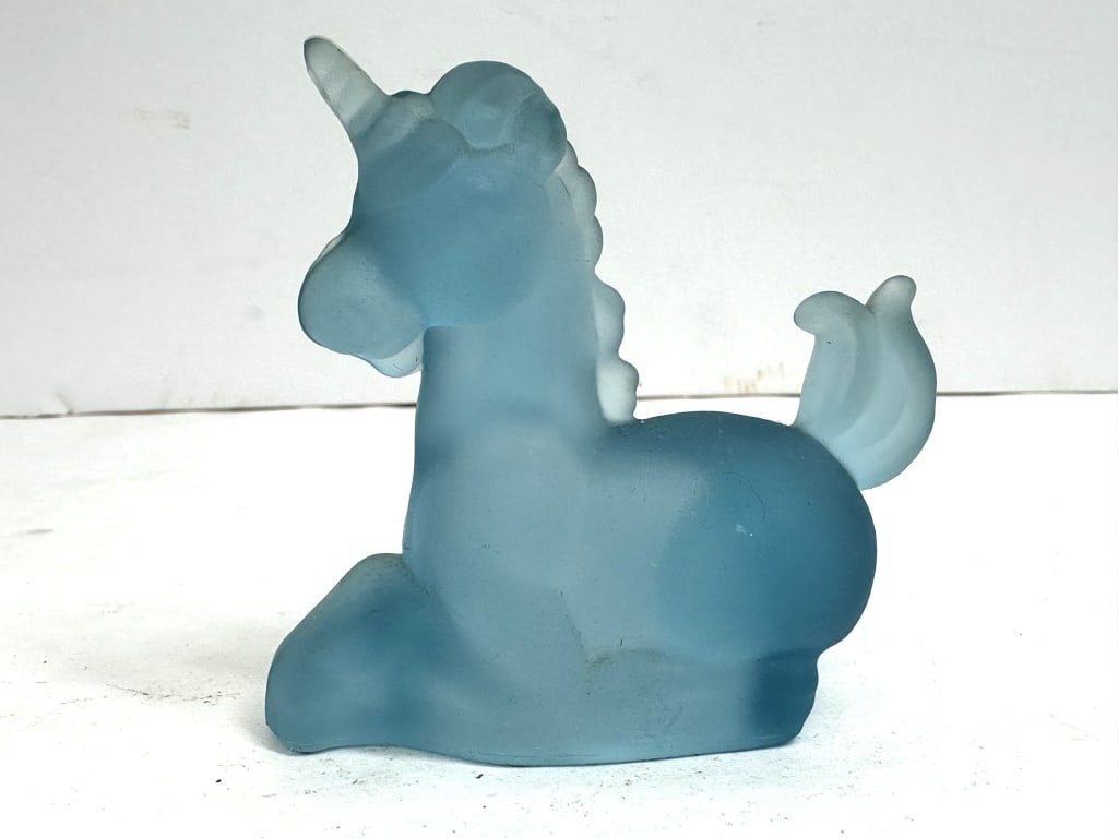 BOYD BLUE FROSTED GLASS UNICORN RARE: Seated unicorn figurine crafted from translucent blue glass featuring a molded, satin finish. A maker mark is present on the lower body, attributed to R. Wetzel.