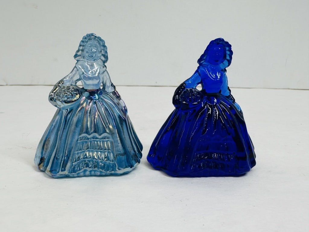 BOYD SOUTHERN BELL FIGURINES BLUE 1978-1983: Pair of pressed glass figurines produced by Boyd's Crystal Art Glass between 1978 and 1983, featuring one iridescent and one cobalt blue example. Both figurines bear the molded Boyd mark on the rear h