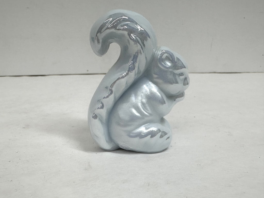 BOYD IRIDESCENT PALE GRAY SQUIRREL: Iridescent pale blue glass squirrel figurine produced by the Imperial Glass Company. The base features a raised I over G mark within a diamond-shaped border.