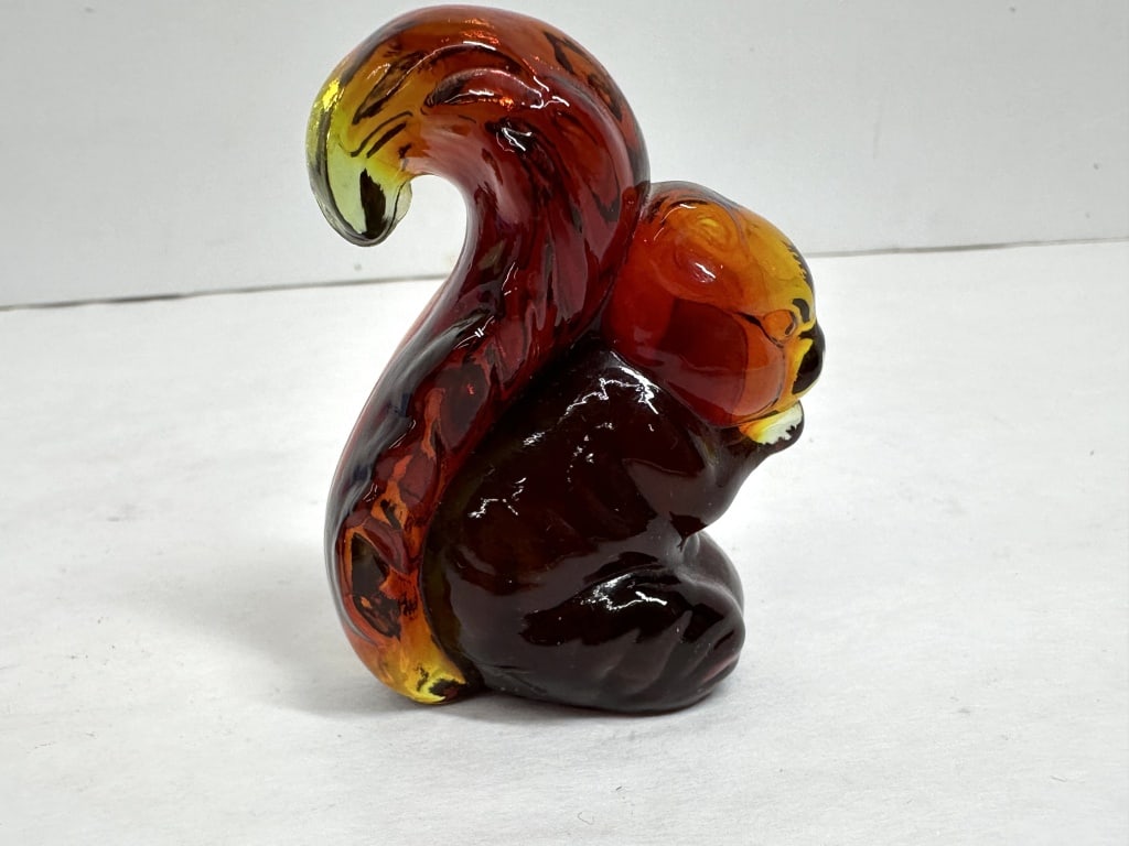 BOYD AMBERINA SQUIRREL: A molded pressed glass squirrel figurine in amberina coloration with molded textures and visible seam lines. The base features a raised P in a square mark for Paden City Glass Manufacturing Company.