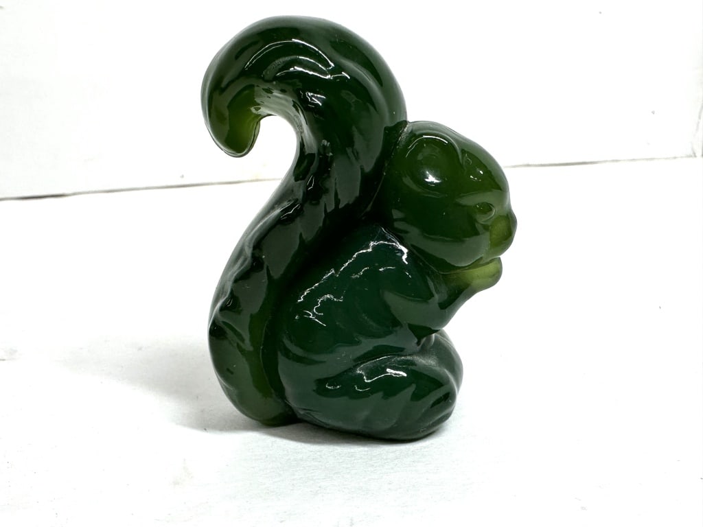 BOYD GREEN GLASS SQUIRREL FIGURINE: Stylized squirrel figurine produced in translucent deep green molded glass with visible vertical mold seams. A circular paper label is affixed to the base with the handwritten inscription JADEITE HH.
