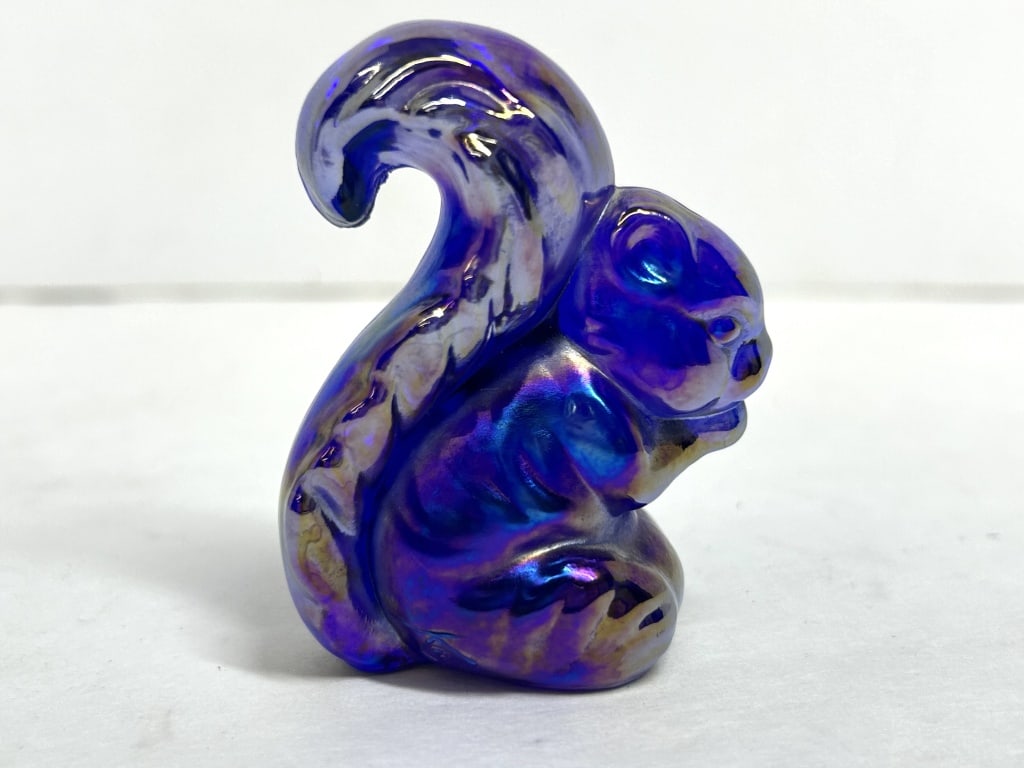 VIBRANT BLUE CARNIVAL BOYD SQUIRREL, MID-20TH CENTURY: Seated squirrel figurine crafted from cobalt blue glass with a vibrant iridescent carnival finish.