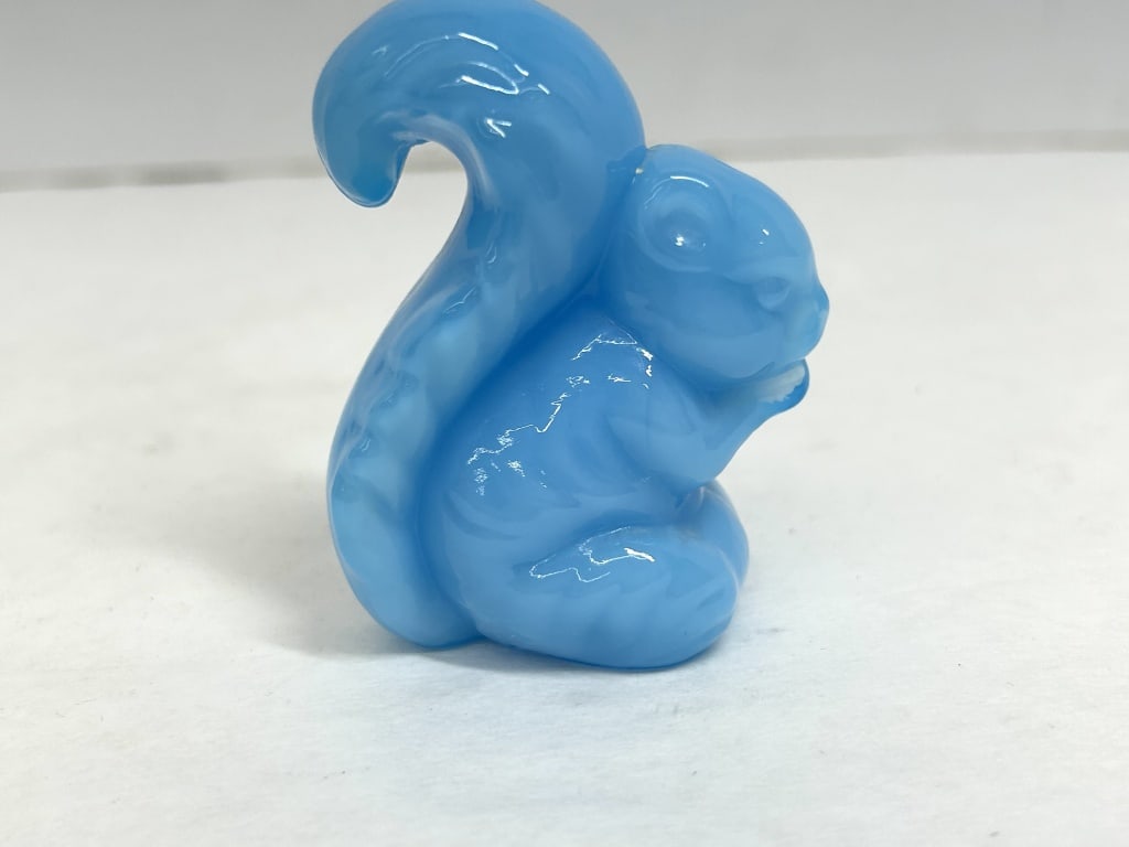 BOYD BLUE GLASS SQUIRREL: A pressed art glass figurine of a seated squirrel crafted from semi-translucent light blue