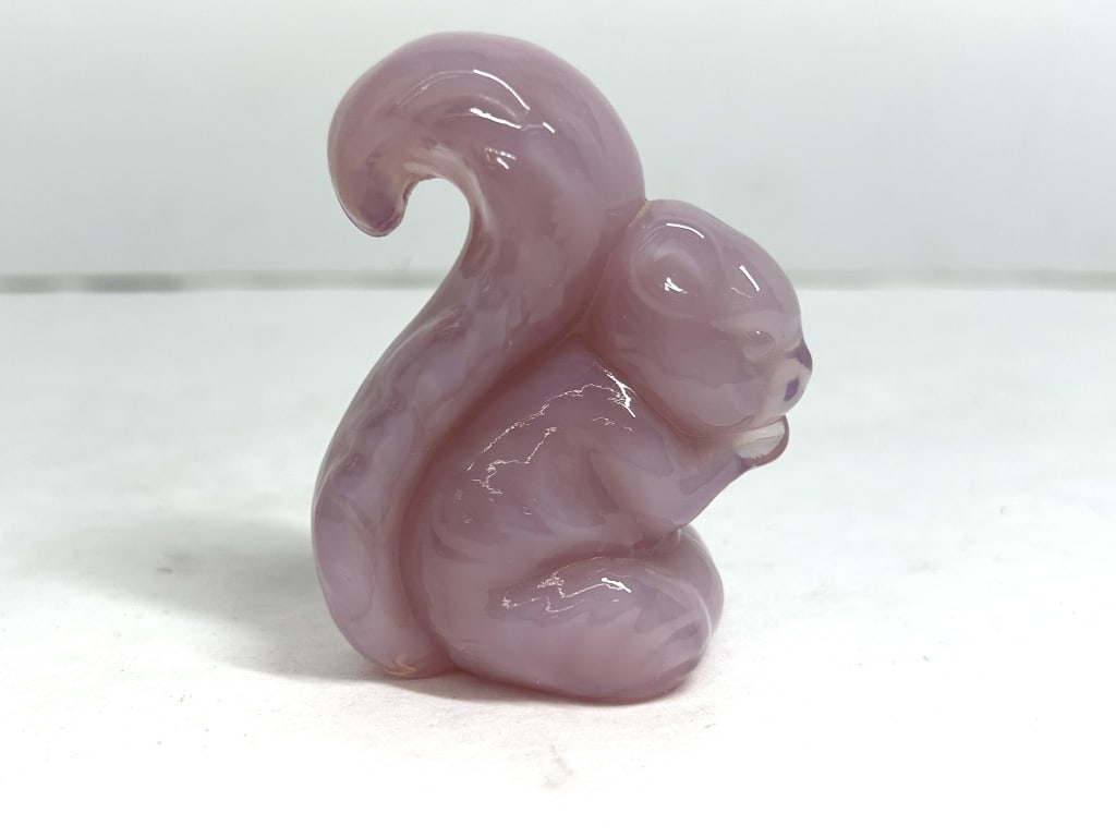 PINK BOYD SQUIRREL FIGURINE: A molded slag glass figurine of a seated squirrel featuring a lavender and white marbleized pattern. The piece displays a high-gloss finish with visible vertical mold seams along the front and back.