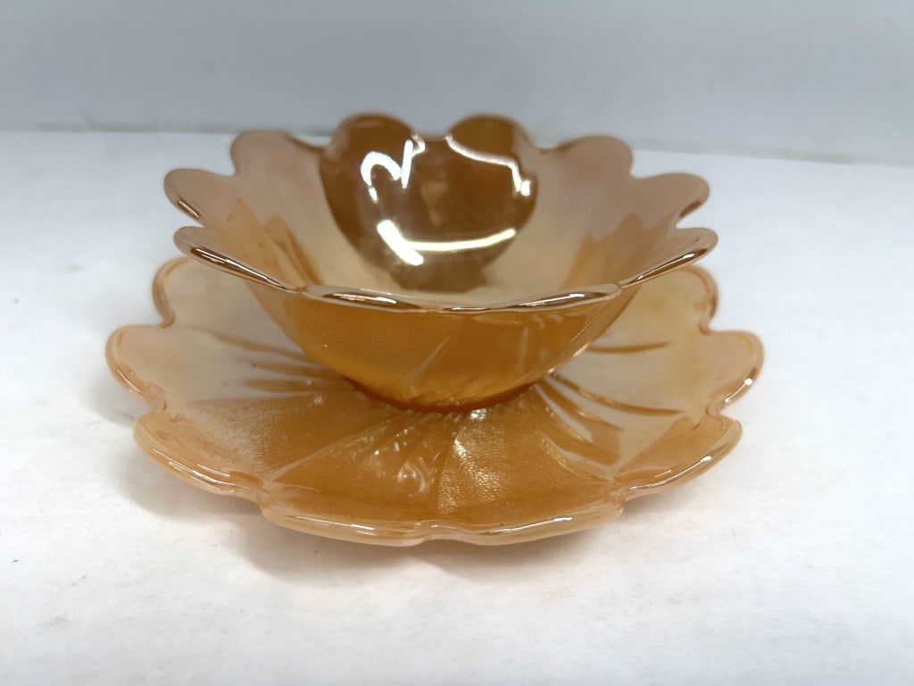 FIRE KING PEACH LUSTER SET, C. 1950: A dessert bowl and matching underplate featuring a ruffled lotus petal design in marigold iridescent glass. The set is attributed to the Fire King Peach Lustre line produced by Anchor Hocking in the