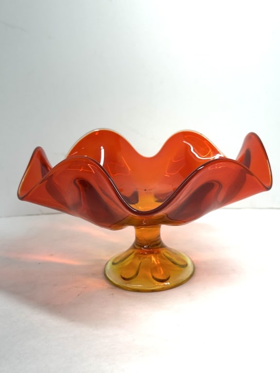 VIKING STYLE AMBERINA COMPOTE, CIRCA 1960: Amberina art glass pedestal bowl featuring a six-petal swung rim and molded foot, attributed to Viking Glass. The piece displays a vibrant color gradient transitioning from deep orange-red at the rim