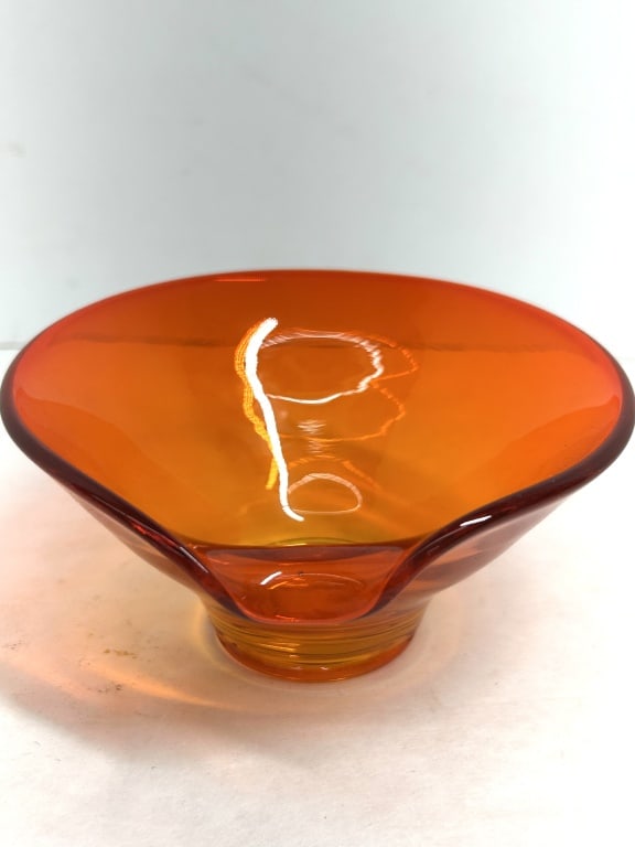 VIKING GLASS BOWL, 1960S: A mid-century modern footed bowl crafted from translucent orange-red glass, featuring a flared conical body with a single pinched rim and tapered pedestal base. The design corresponds to the Epic