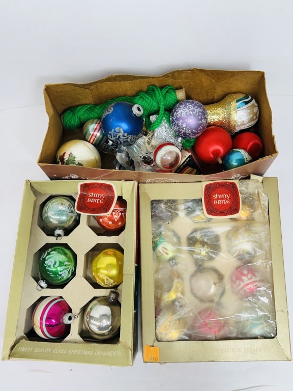SHINY BRITE GLASS CHRISTMAS ORNAMENTS: A collection of vintage mercury glass ornaments manufactured by Shiny Brite, presented in two original retail boxes and an additional unbranded bulk lot. The assortment includes a variety of spherical