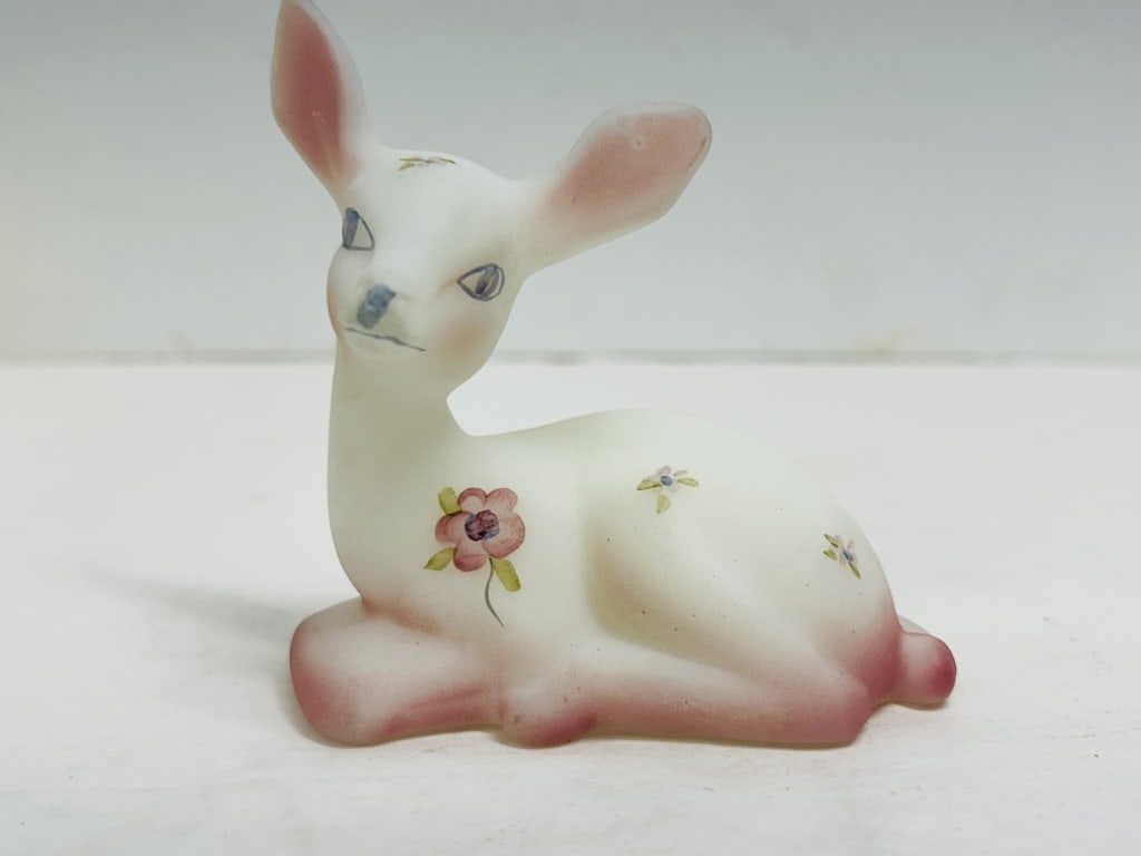 FENTON BURMESE GLASS DEER FIGURINE: Hand-painted Burmese glass deer figurine produced by Fenton Art Glass Company featuring floral and berry motifs. The underside of the base is hand-signed by decorator Donna Hart.