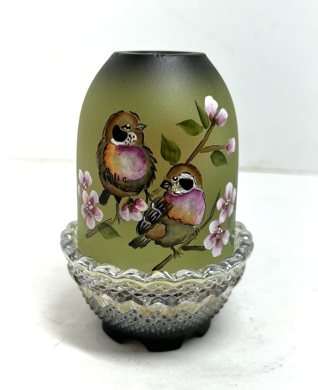 FENTON PAINTED GLASS FAIRY LAMP: A two-piece Fenton Art Glass fairy lamp consisting of a hand-painted satin green shade and a clear pressed glass base. This single lamp accommodates a tealight or votive candle and features the emboss